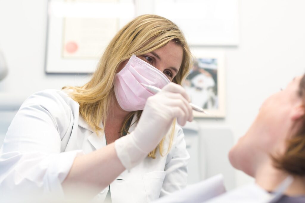 A dentist examining a patient teeth with dental instruments