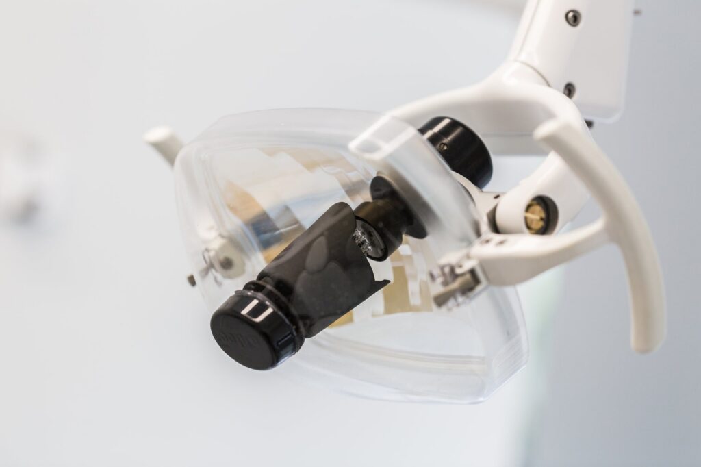 A dental curing light resting in its holder