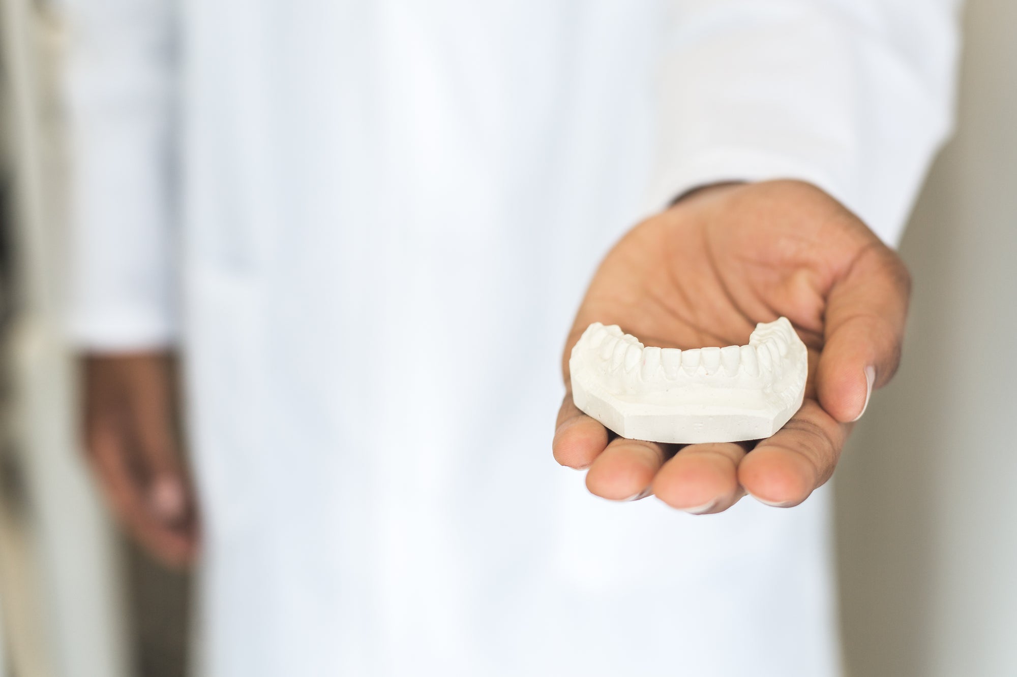 Hand Holding Dental Mold